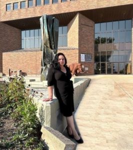 Curative Connections participant Luz poses in front of a building.
