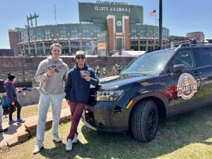 Jack and Luke of MyDraft Experience Booklet pose in front of Lambeau Field.
