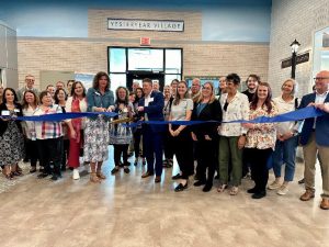 A photo of the ribbon cutting ceremony for Yesteryear Village at Curative Connections.